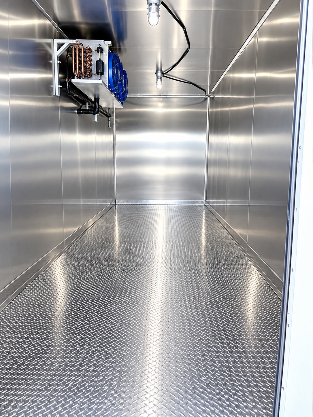 Inside a 20 ft refrigerated trailer: stainless steel walls, diamond-plate floor and a ceiling-mounted cooling unit